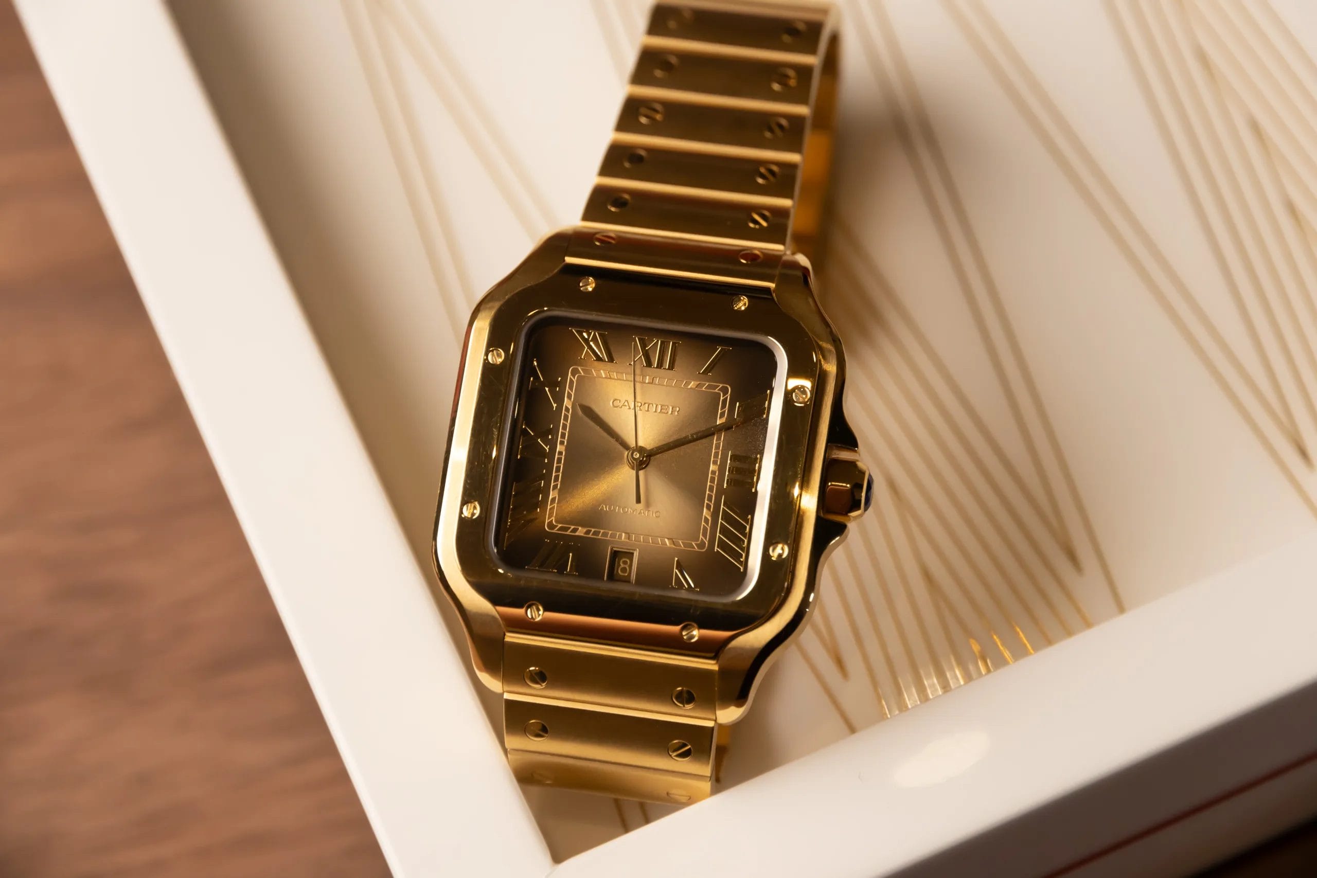 The Santos de Cartier Glows in A Cinematic Gold